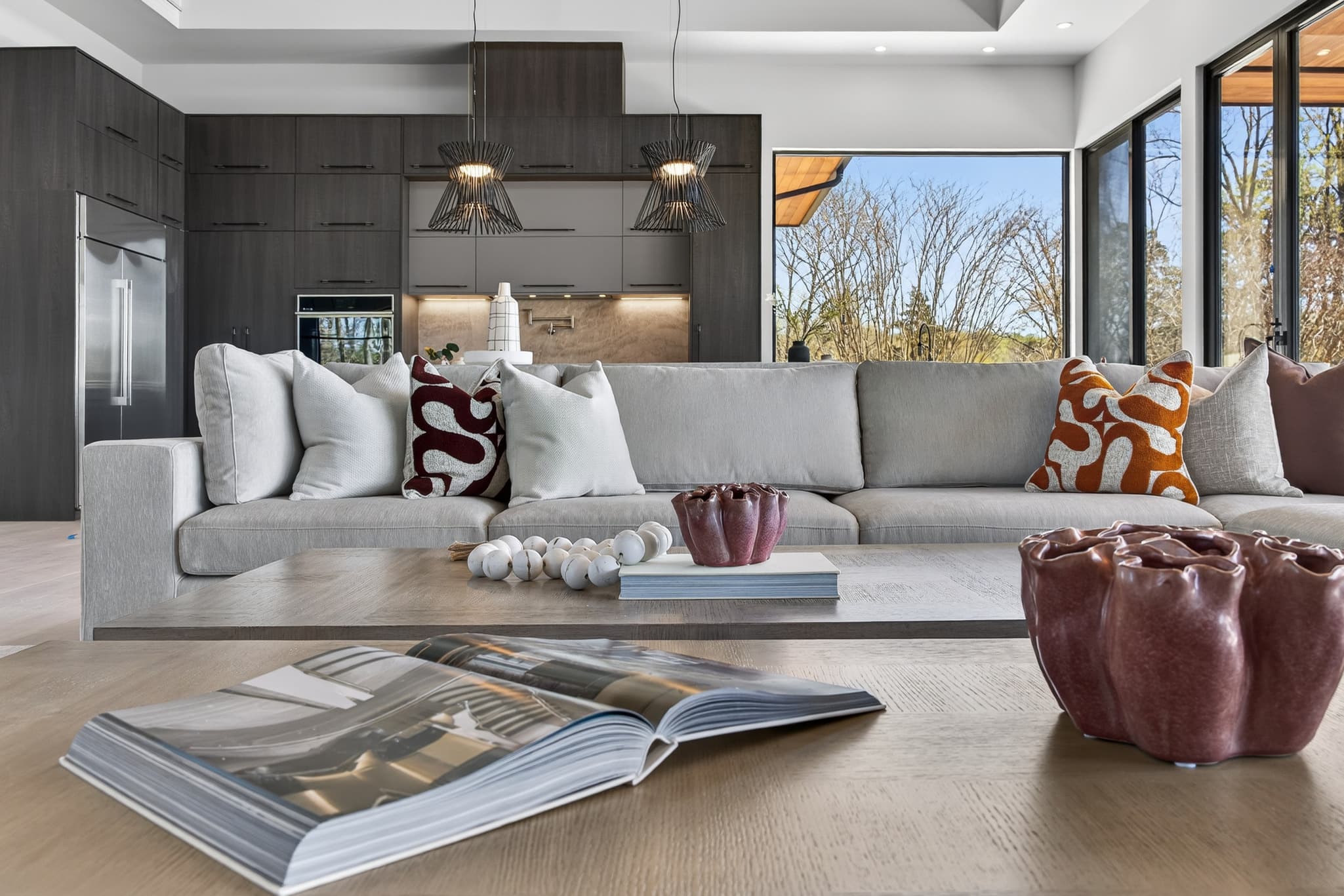 Luxury loft living and dining area with floor-to-ceiling windows and city skyline view — slide 1 of 4