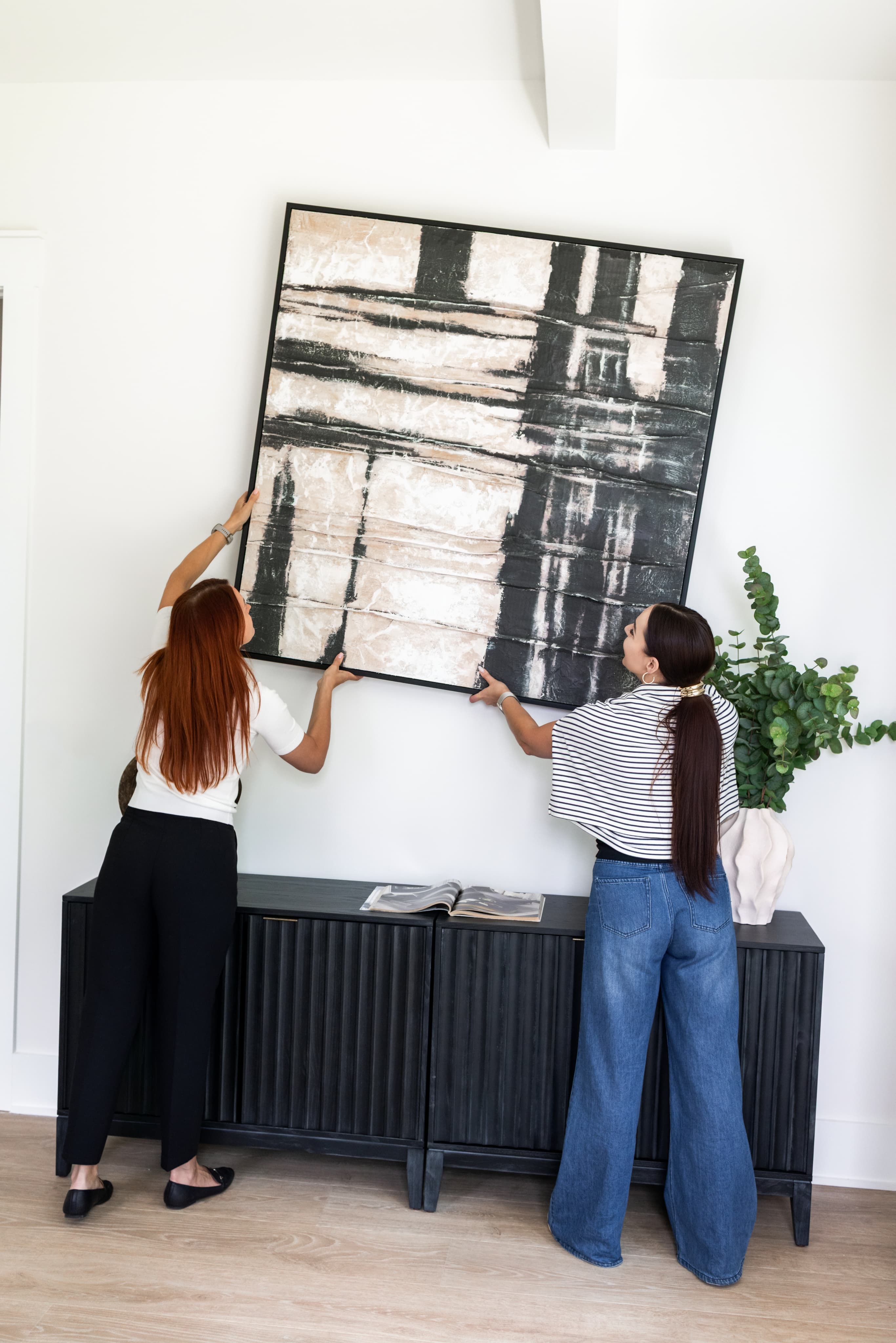 TNT Staging team member arranging home decor