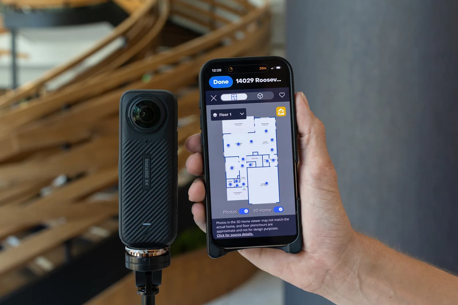 Insta360 camera beside a phone displaying a captured property floor plan